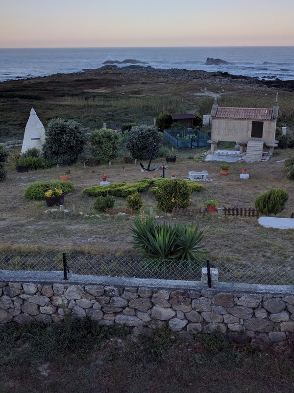 A yard and garden with small horreo and missile cone tent.