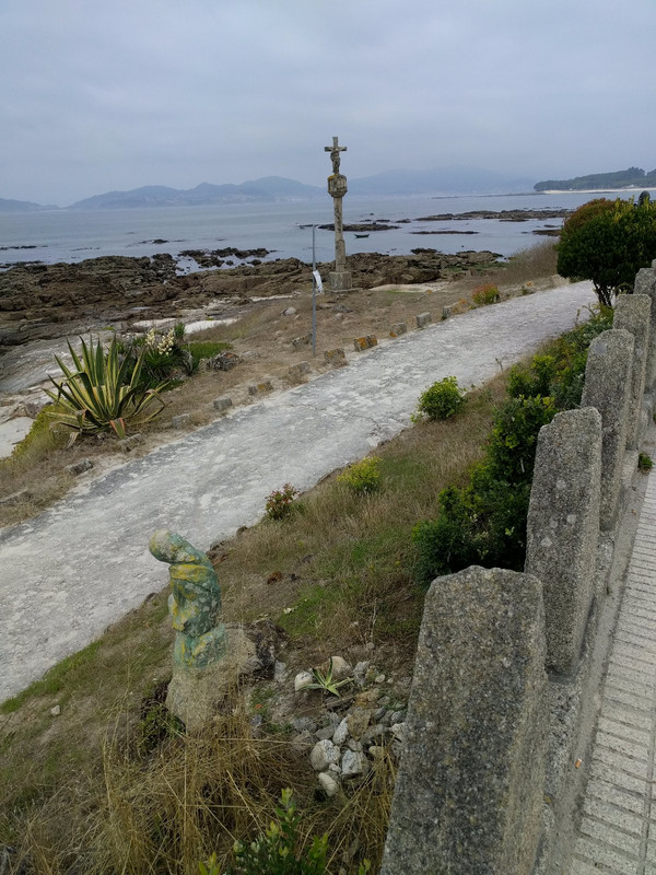 A small Madonna and wayside cross along the beach