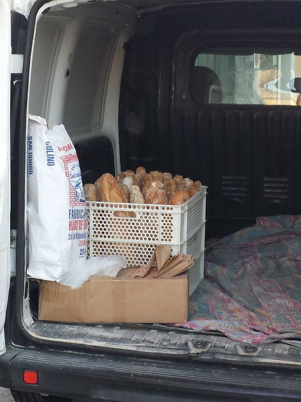 The bread man with his van delivering to restaurants, bars and homes.