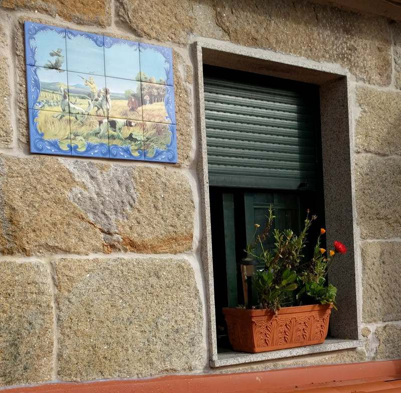 Azulejos hunting scene on this house near window and planter