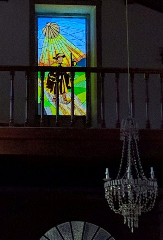 stained glass window of St James from inside church