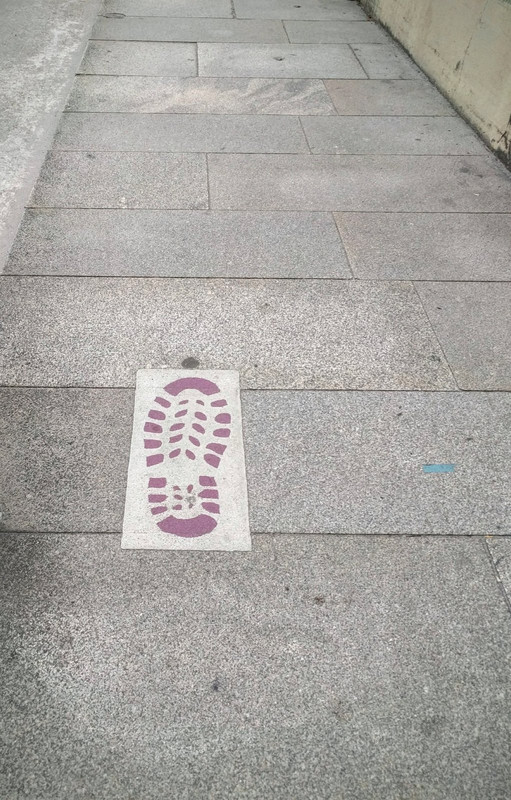 These footprint way marks to Muxia and Fisterre on the streets of Santiago.