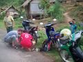 Villagers helping to fix the scooter
