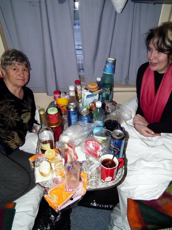 Anjelica, the babushka and our overflowing table on the Moscow - Labytnangi train