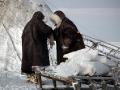 Nenets people outside chum by reindeer sledge, Yamal Peninsula