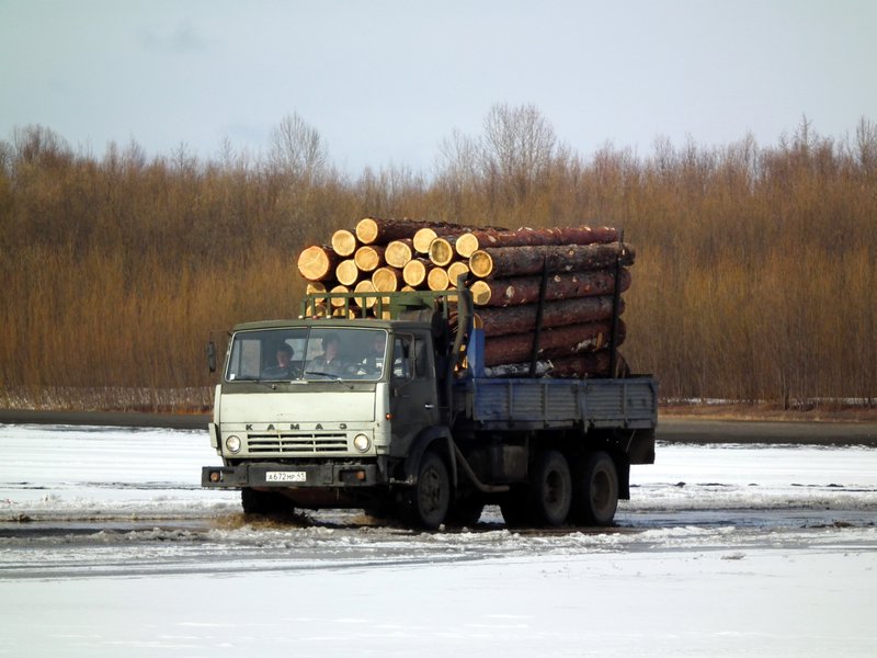 A truck driving across the frozen river on the way to Klyuchi