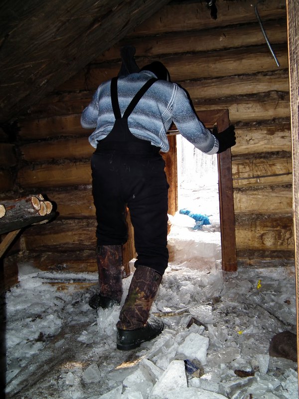 Clearing the ice out of the log cabin after we had broken it up, 100km from Anavgay, Kamchatka