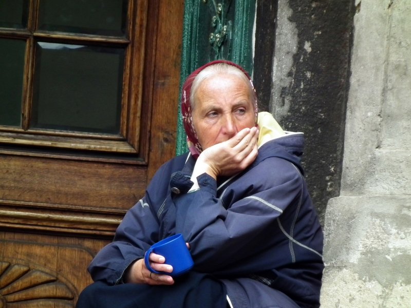 Babushka begging outside church, Lviv