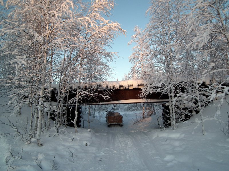 Our snowmobile under a bridge of the abandoned 501 Salekhard - Igarka Railway of Death, Nadym Region, Siberia
