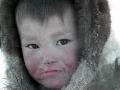 A Nenets child after drinking blood and eating raw meat from a reindeer carcass, Nadym Region, Siberia