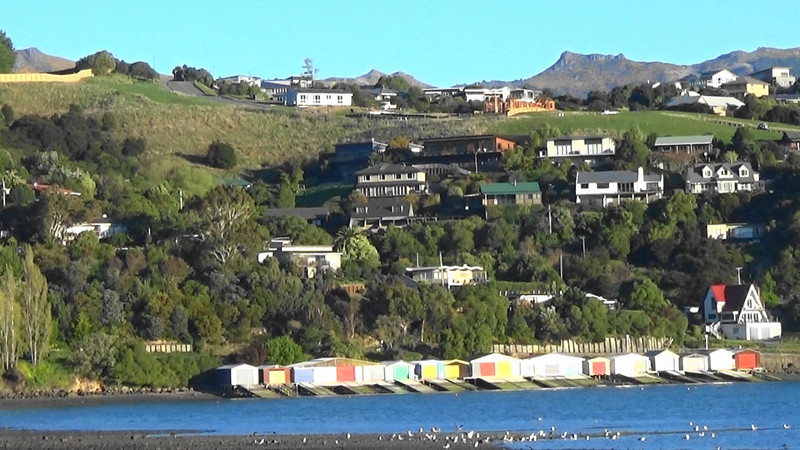 Multi coloured seaside boat sheds at Robinsons Bay,Akaroa Harbour
