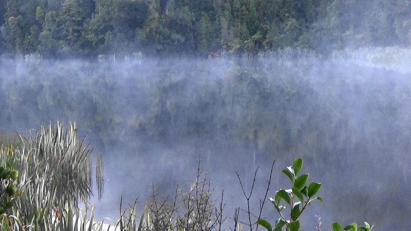 Light mist swirls on Lake Mathieson