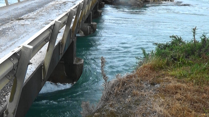 Incoming tidal surge under a bridge