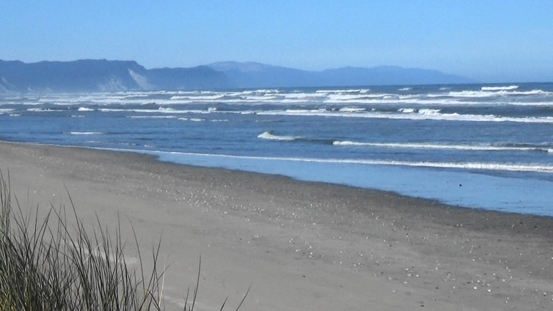Ocean waves into the estuary looking south from Karamea