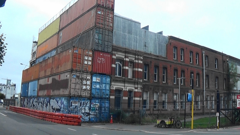 Containers holding back building not yet repaired after earthquake 11 years ago