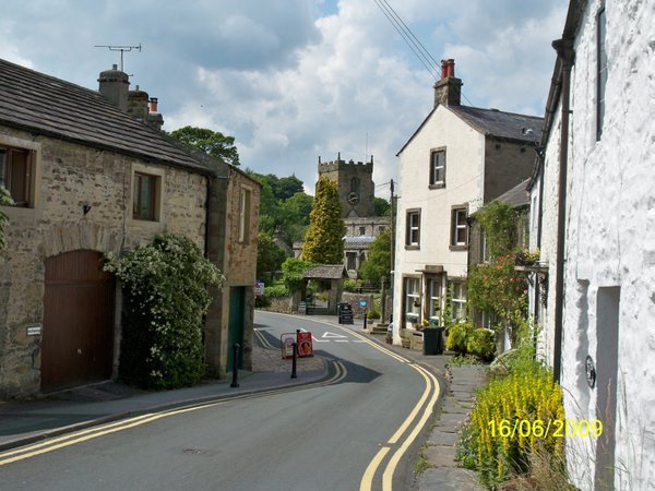Main street Giggleswick with church tower in distance