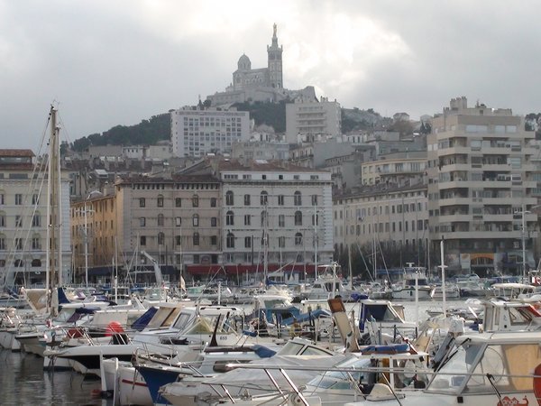 The Marseille marina and church on the hill in the background