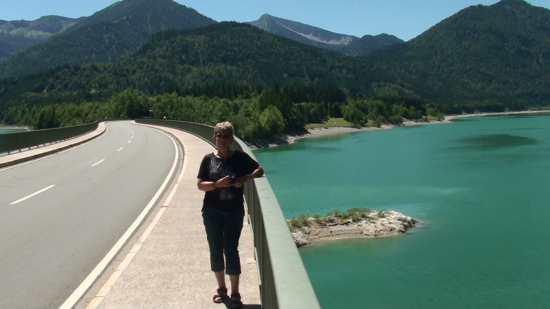 Gretchen on the road bridge over lake with Austrian Alps in background