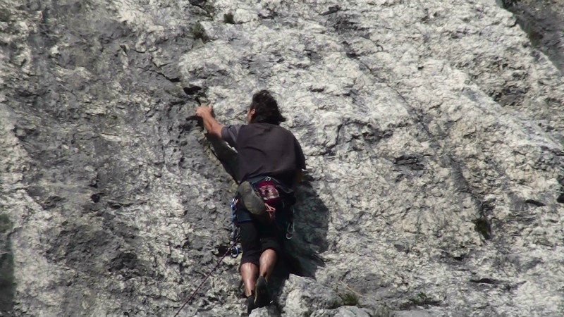 Climber making amazing progress up the rock face