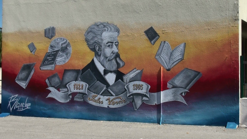 A painting of Jules Verne who wrote 'Around the World in 80 Days'on a school wall at Port St Louis,very approriate to us travellers