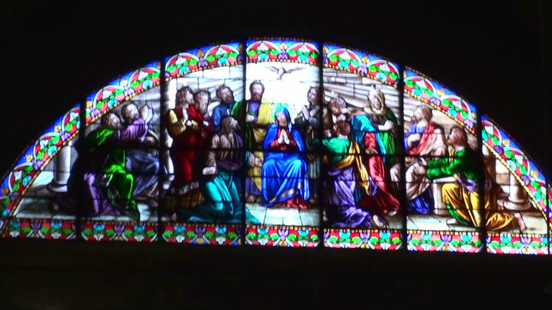 A colourful stainglass window above the altar