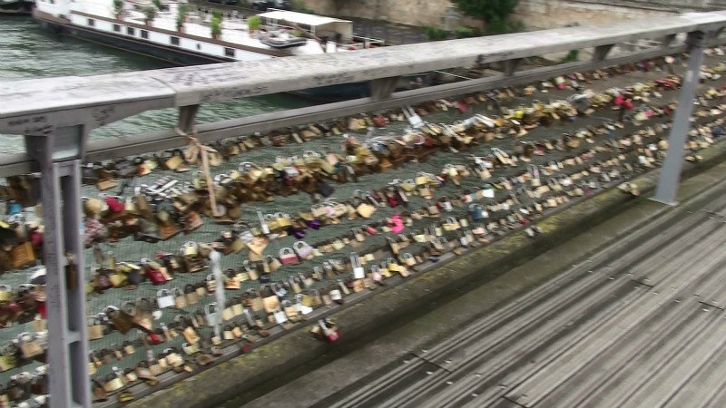 Padlocks by the thousands on a bridge over the River Seine