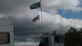 Flags of Scotland and England fly on the border