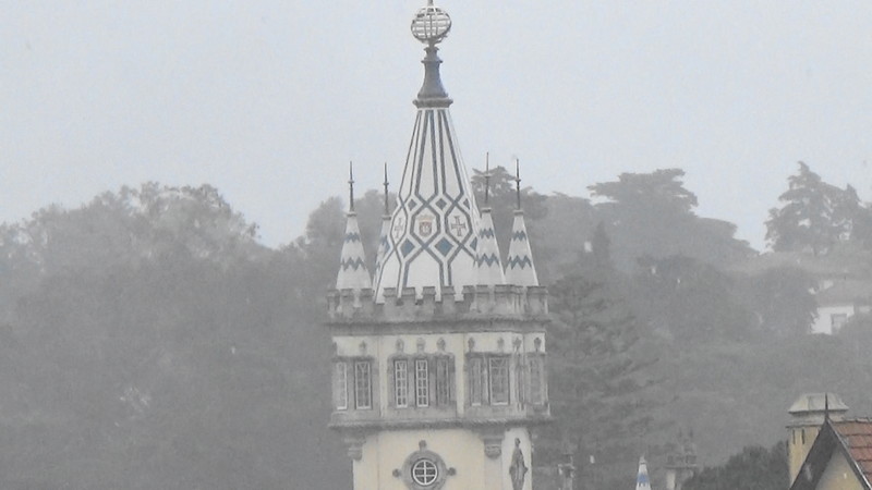 Spire on another castle away in the drizzly rain,Sintra