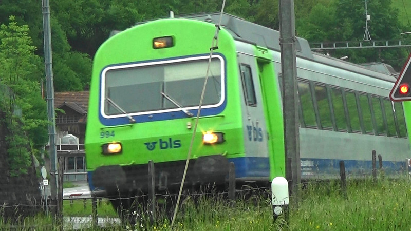 Swiss train with right of way on a railway crossing