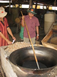Big pan with hot sand for rice popping