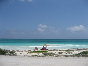 Mexican family enjoying a day on the deserted beaches of Sian Ka'an