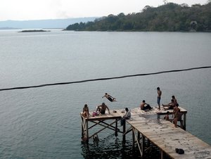 Kids jumping into Lago Peten