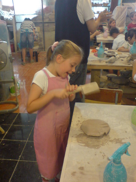 Sophie bashing the clay