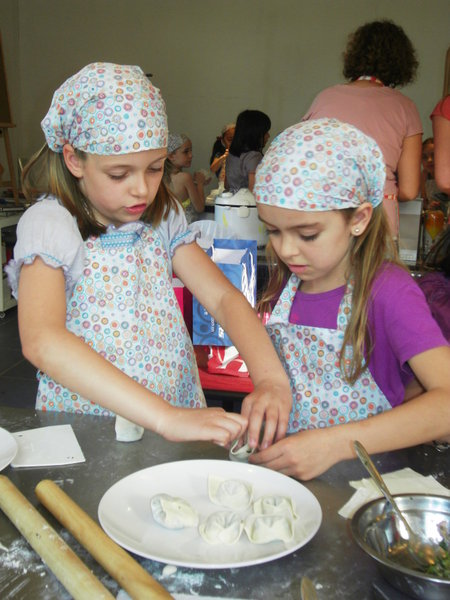 Sophie showing Em how to make dumplings