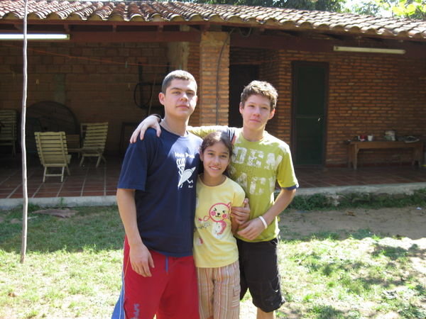 My siblings Luichi, Luz, and Juan (entrance to my room in back)