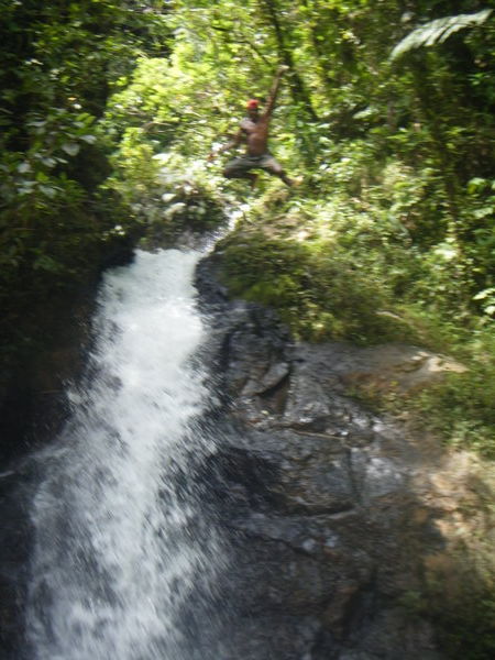man jumping from waterfall