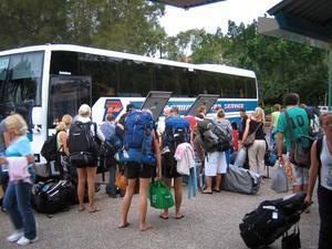 Backpackers pile onto the bus.