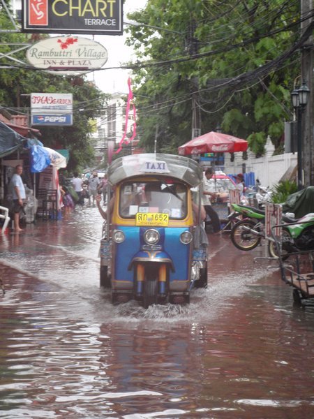 Tuk-tuk on a flooded road