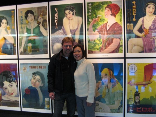 Yuki and me in front of beer posters featuring women