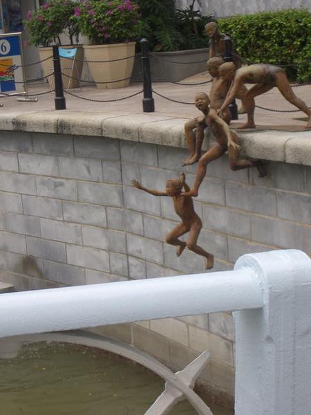 Statues jumping into the river
