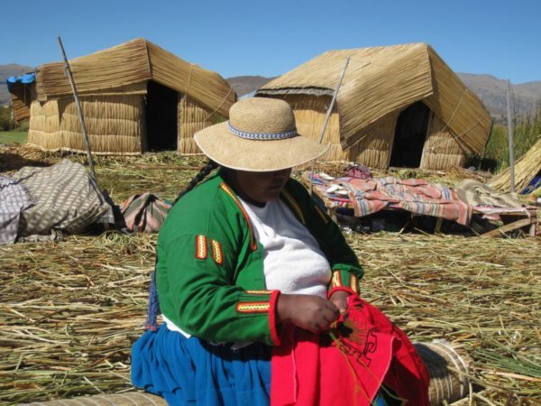 Lady sewing on Uros reed island