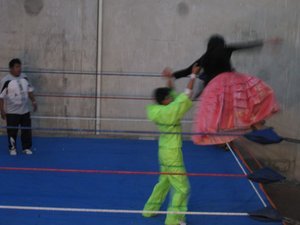 Blovian female wrestler  jumping off the ropes