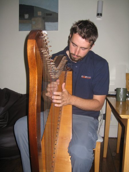 Dav playing the harp at Michael's place