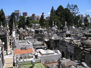 Looking over the famous Recoleta cemetary of tombs with highrise aparments in the distance