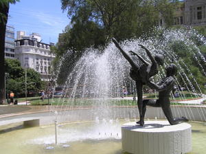 Graceful statue & fountain in small park square