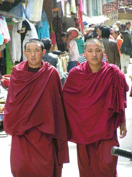 Tibetan monks in a small market street