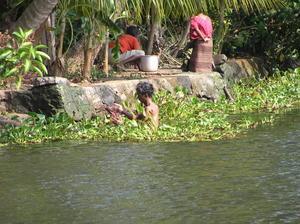 Man bathing, women washing clothing - every day life on the canal