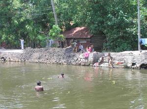 Villagers bathing in the river & doing laundry