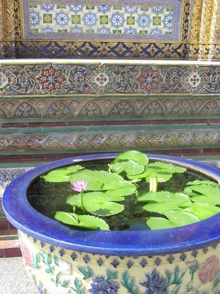 Ornate detail of temple with revered lotus plants outside