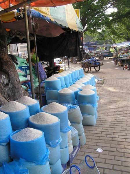 Bags of varying grains of rice for sale on the street
